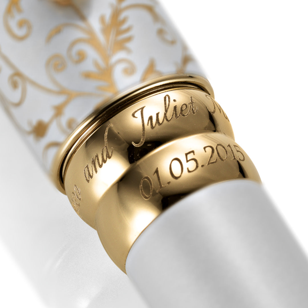 Personalized gold rings engraved with names and wedding date on the Wedding Pen Legacy Edition.